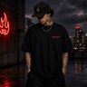 Model wearing Rebel Mythic Oversized Tee in urban night setting