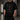 Model wearing the black Multiversity Glitch Transfer Tee showing the front graphic and relaxed fit